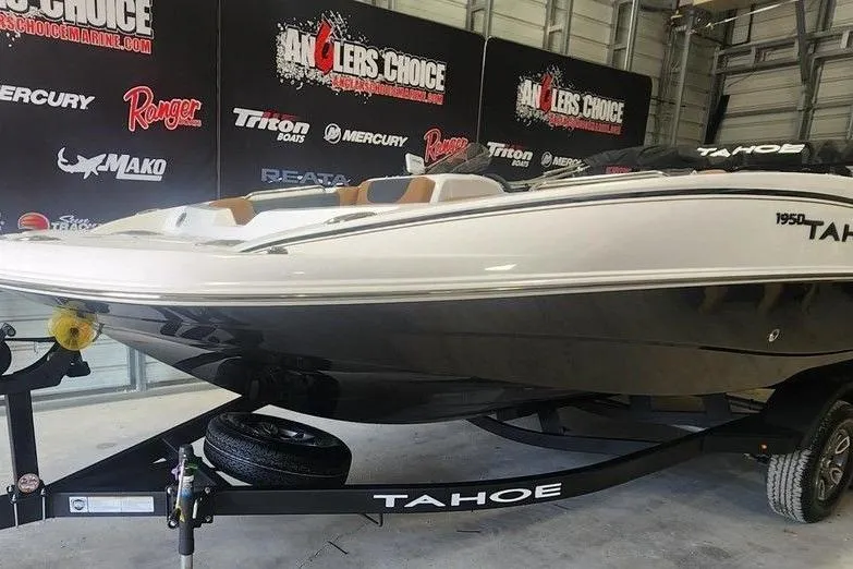 Slide: The Image of 2026 Tahoe 1950 boat on trailer in showroom, Angler's Choice backdrop. - 5