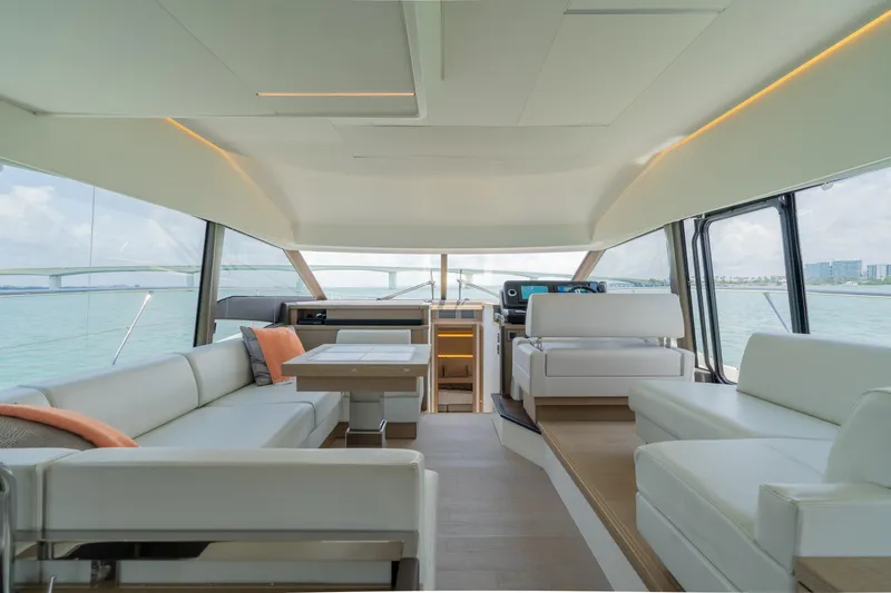 Slide: The Image of Interior of 2019 Prestige 520 Flybridge yacht with modern seating and panoramic windows. - 12