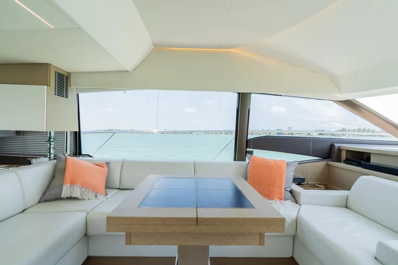 Slide: The Image of Interior of 2019 Prestige 520 Flybridge yacht with white seating and ocean view. - 15