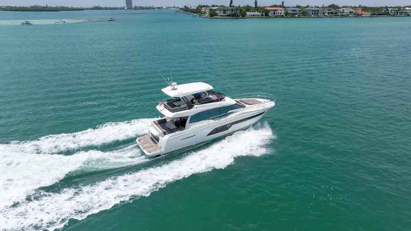 Slide: The Image of 2019 Prestige 520 Flybridge yacht cruising on open water. - 2