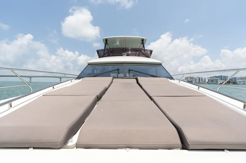 Slide: The Image of 2019 Prestige 520 Flybridge yacht with sun loungers on deck. - 26