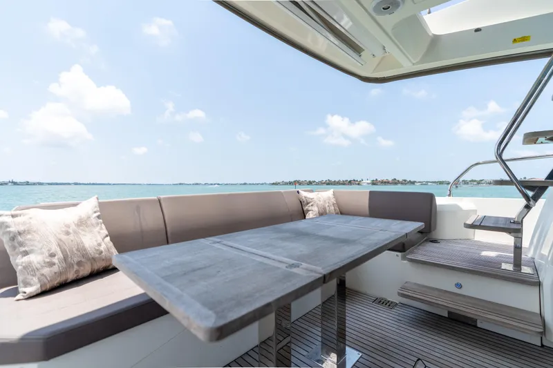 Slide: The Image of 2019 Prestige 520 Flybridge yacht with outdoor seating and ocean view. - 31