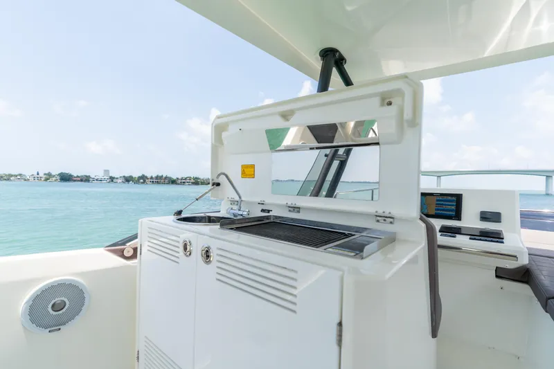 Slide: The Image of Prestige 520 Flybridge 2019 yacht outdoor kitchen with ocean view. - 38