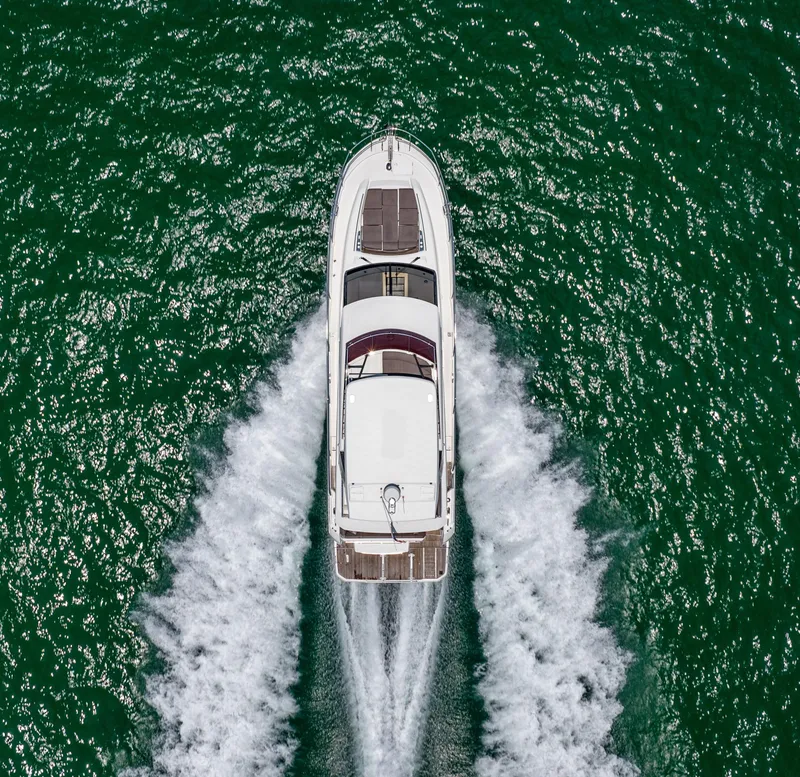 Slide: The Image of Aerial view of a 2019 Prestige 520 Flybridge yacht cruising on green water. - 40