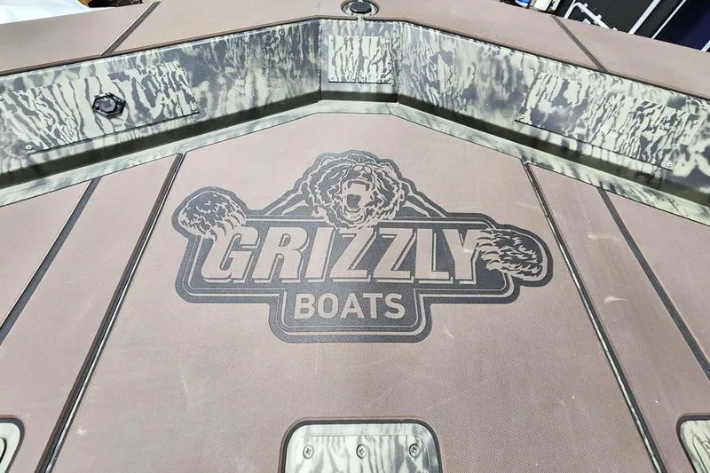 Slide: The Image of 2026 Tracker Grizzly 2072 CC boat deck with Grizzly Boats logo. - 12