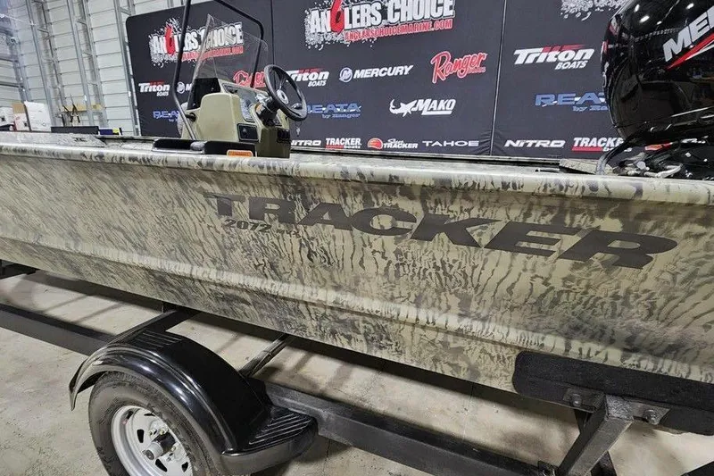 Slide: The Image of 2026 Tracker Grizzly 2072 CC boat on display with camouflage design. - 4