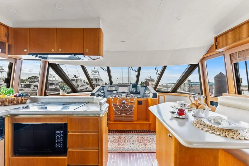 Slide: The Image of Luxurious interior of 2000 West Bay 58 Sonship yacht with modern kitchen and helm. - 11