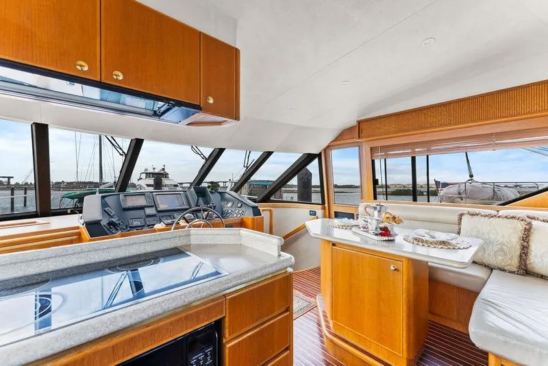 Slide: The Image of Luxurious interior of 2000 West Bay 58 Sonship yacht with modern kitchen and dining area. - 12