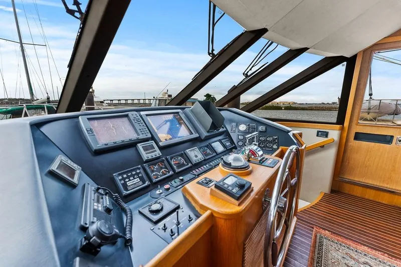 Slide: The Image of Helm of 2000 West Bay 58 Sonship yacht with navigation instruments and wooden steering wheel. - 14