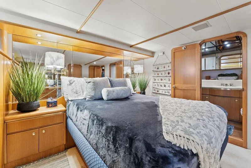 Slide: The Image of Luxurious bedroom interior of 2000 West Bay 58 Sonship yacht with elegant decor. - 16