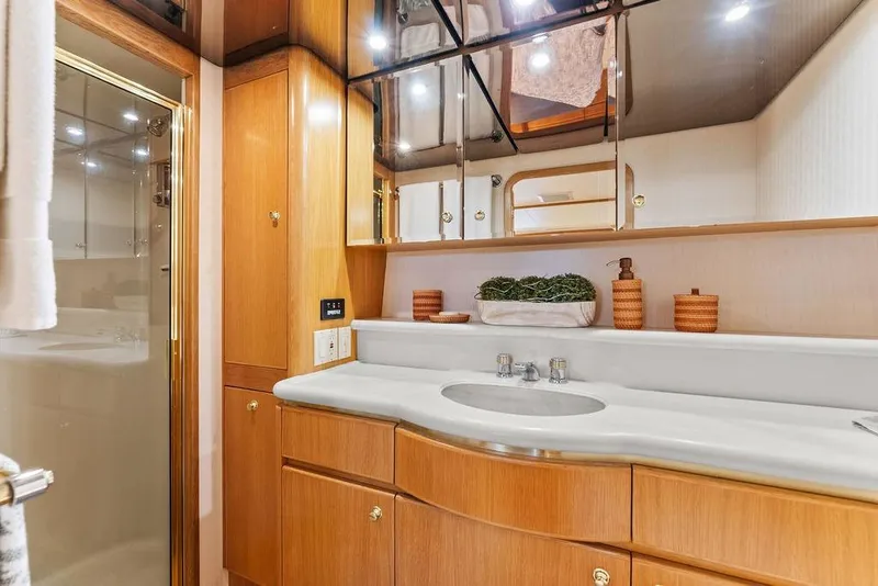 Slide: The Image of Luxurious bathroom in 2000 West Bay 58 Sonship yacht with elegant wood cabinetry. - 19