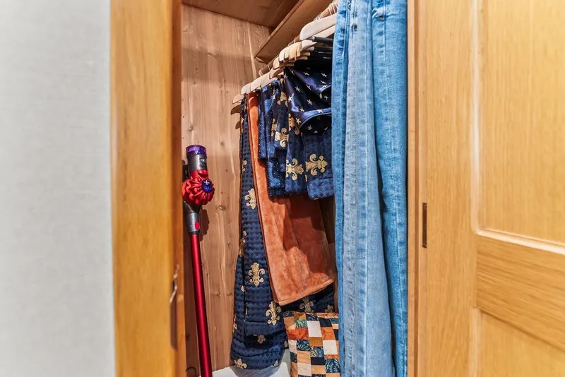 Slide: The Image of Closet interior on 2000 West Bay 58 Sonship yacht with clothes and vacuum. - 21