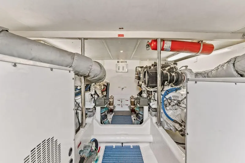 Slide: The Image of Engine room of 2000 West Bay 58 Sonship yacht, featuring mechanical equipment and fire extinguisher. - 28