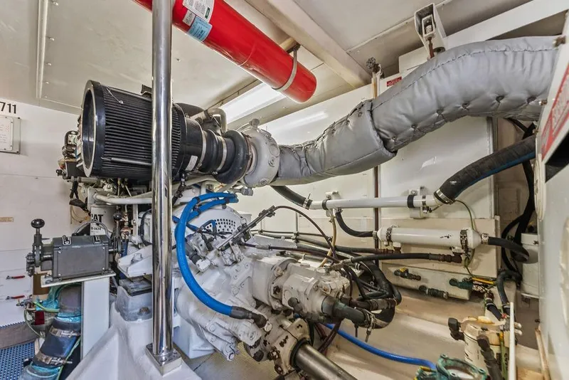 Slide: The Image of Engine room of 2000 West Bay 58 Sonship yacht, featuring complex machinery and piping. - 30