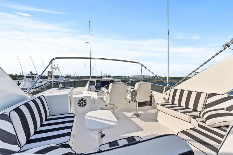 Slide: The Image of 2000 West Bay 58 Sonship yacht interior with striped seating and helm view. - 33
