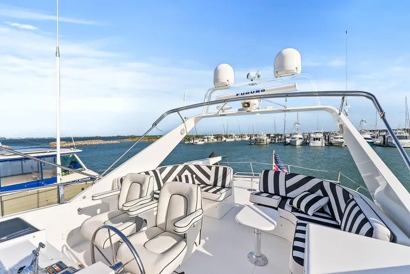 Slide: The Image of Luxurious 2000 West Bay 58 Sonship yacht with stylish seating, docked in a scenic marina. - 35