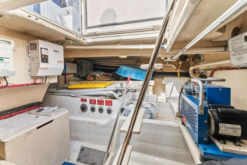 Slide: The Image of Engine room of 2000 West Bay 58 Sonship yacht, featuring equipment and control panels. - 39