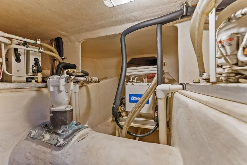 Slide: The Image of Engine room of 2000 West Bay 58 Sonship yacht, showcasing mechanical components and piping. - 41