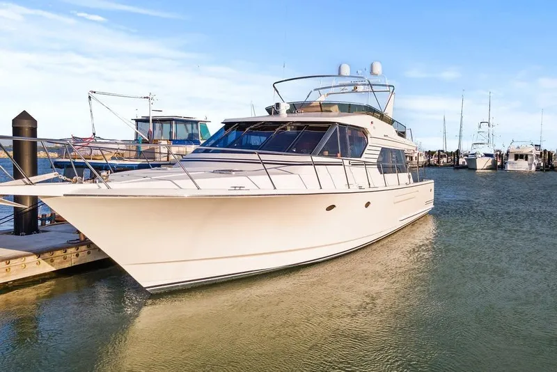 Slide: The Image of Luxury 2000 West Bay 58 Sonship yacht docked in marina, clear blue sky. - 48