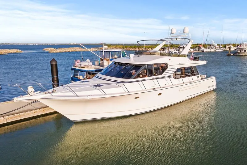 Slide: The Image of Luxury 2000 West Bay 58 Sonship yacht docked in a serene marina setting. - 5