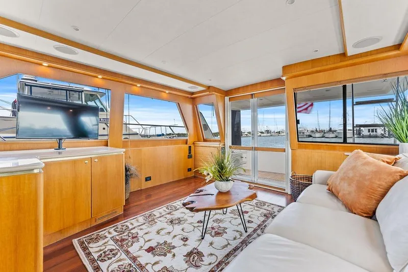 Slide: The Image of Luxurious interior of 2000 West Bay 58 Sonship yacht with elegant furnishings and large windows. - 9