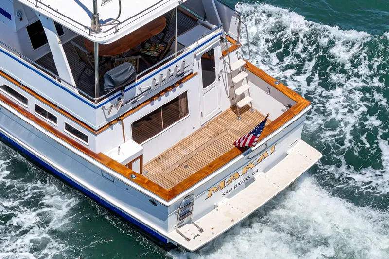 Slide: The Image of 1986 Offshore Yachts Cockpit Motoryacht at sea, American flag waving. - 2