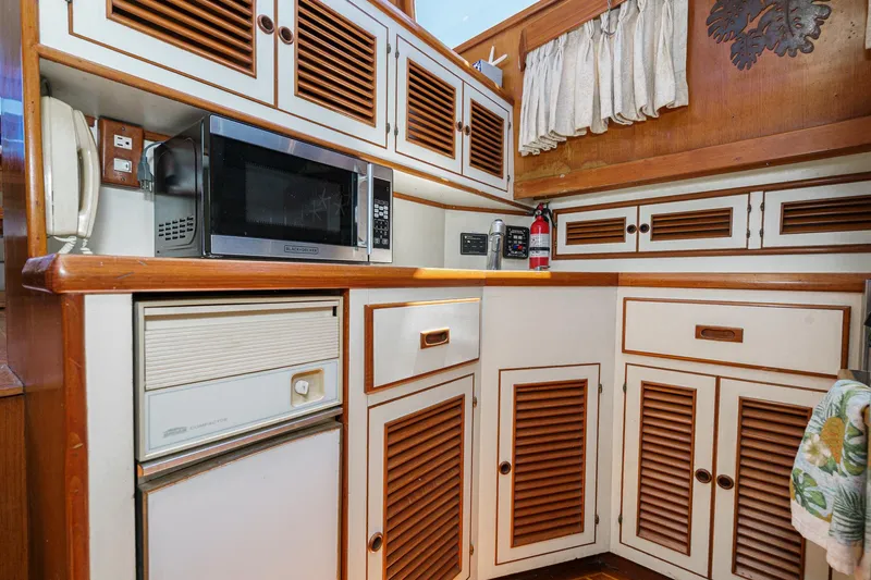 Slide: The Image of 1986 Offshore Yachts Cockpit Motoryacht kitchen area. - 18