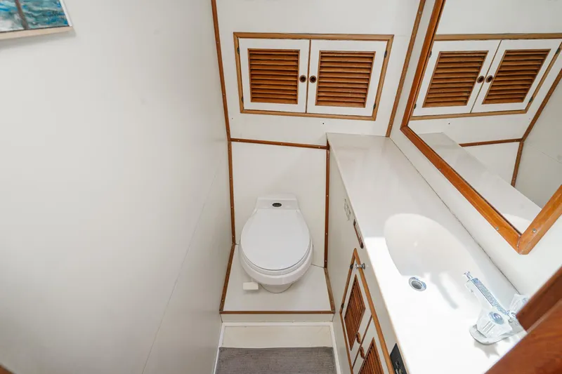 Slide: The Image of Bathroom of a 1986 Offshore Yachts Cockpit Motoryacht with toilet and sink. - 28