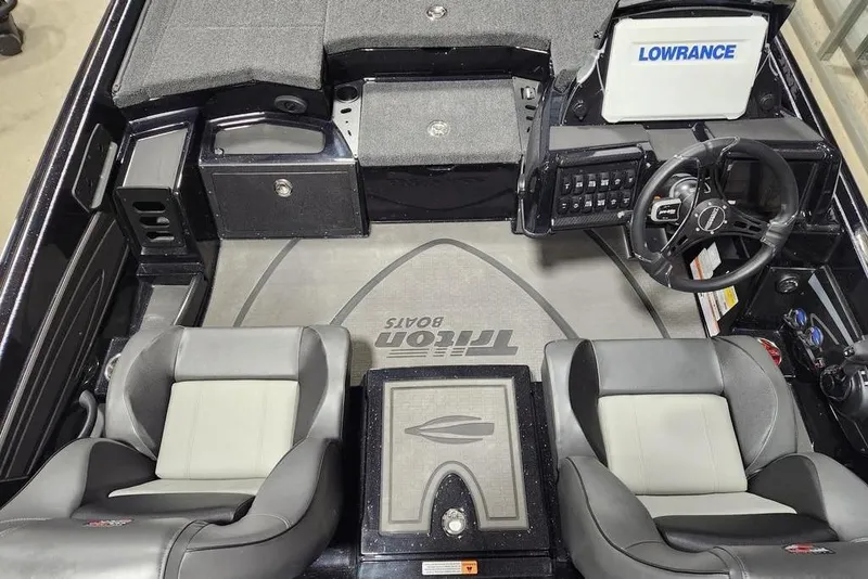Slide: The Image of 2026 Triton 20XP Patriot boat interior with dual seats and Lowrance electronics. - 9