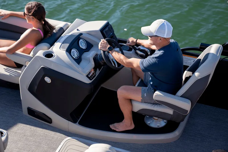 Slide: The Image of Man steering Barletta Cabrio 22 U boat on the water. - 3