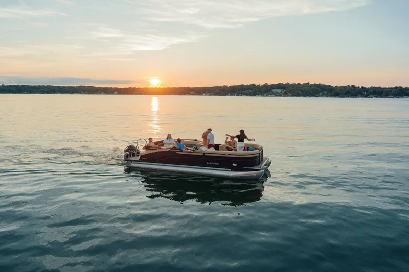Slide: The Image of Harris Cruiser 210 boat on lake at sunset, 2026 model. - 17