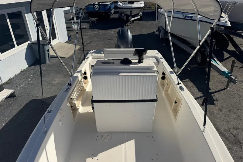 Slide: The Image of 2001 Sea Fox 195 Bay Fisher boat with canopy, parked on asphalt. - 13