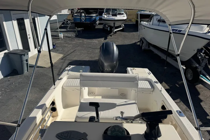 Slide: The Image of 2001 Sea Fox 195 Bay Fisher boat with outboard motor, parked in a marina. - 15