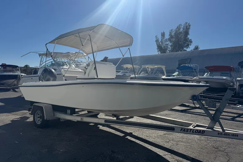 Slide: The Image of 2001 Sea Fox 195 Bay Fisher boat on trailer under sunny sky. - 2