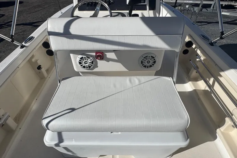 Slide: The Image of 2001 Sea Fox 195 Bay Fisher boat interior with white seating and built-in speakers. - 23