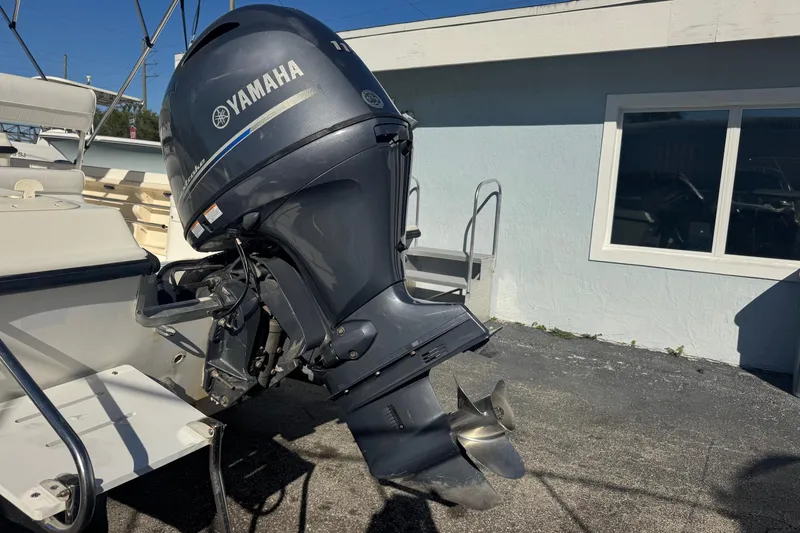 Slide: The Image of Sea Fox 195 Bay Fisher 2001 with Yamaha outboard motor, parked near a building. - 29