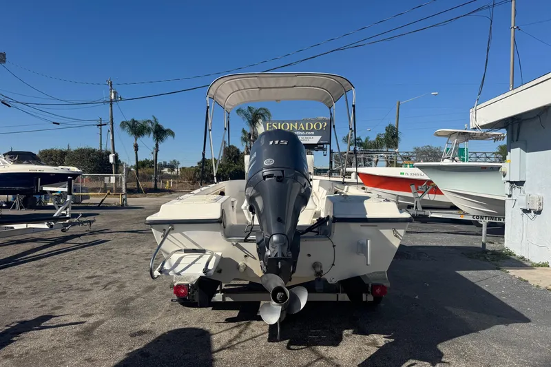 Slide: The Image of 2001 Sea Fox 195 Bay Fisher boat with outboard motor in a sunny marina. - 3