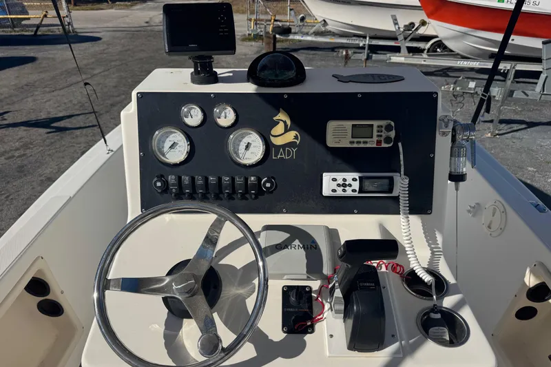 Slide: The Image of Console of a 2001 Sea Fox 195 Bay Fisher boat with steering wheel and gauges. - 5