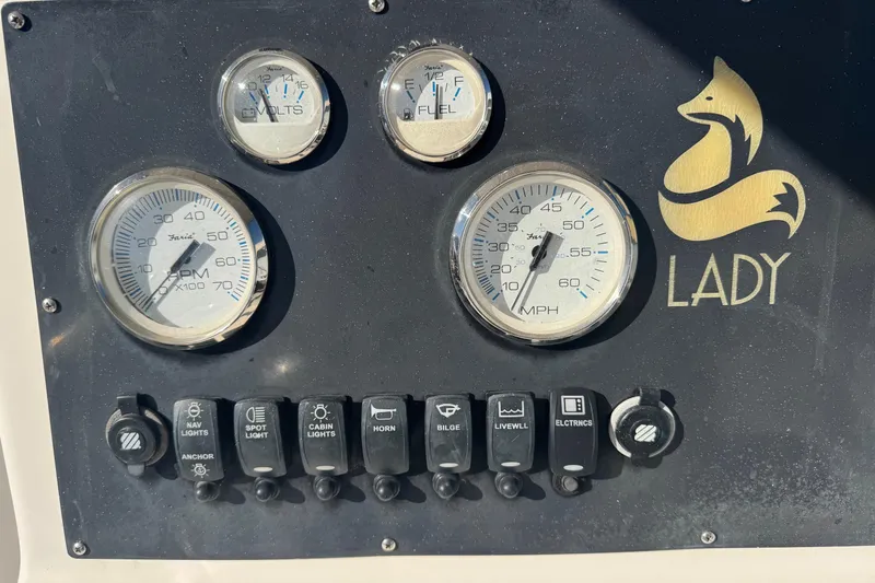 Slide: The Image of Control panel of a 2001 Sea Fox 195 Bay Fisher boat with gauges and switches. - 7