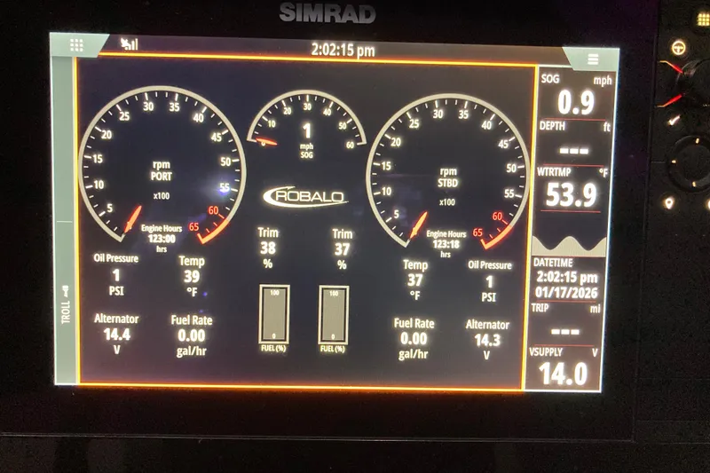 Slide: The Image of 2022 Robalo R272 Center Console boat interior with cushioned seating on calm water. - 13