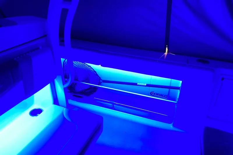 Slide: The Image of 2022 Robalo R272 Center Console boat docked in a marina, showcasing spacious seating. - 14