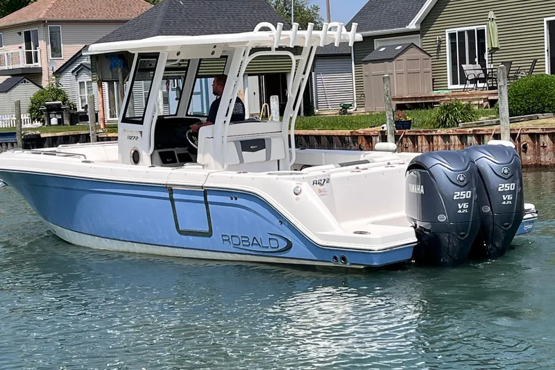 Slide: The Image of 2022 Robalo R272 Center Console boat docked with twin Yamaha 250 engines. - 3