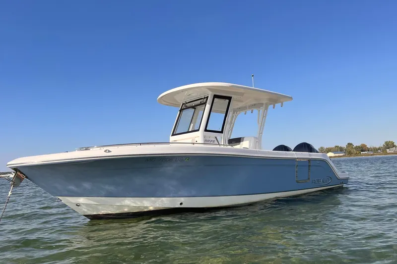Slide: The Image of 2022 Robalo R272 Center Console boat interior with steering wheel and control panel. - 4