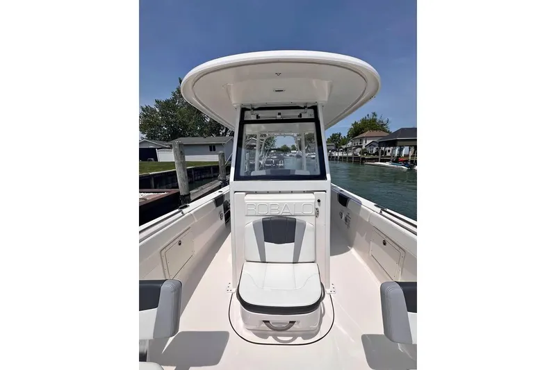 Slide: The Image of 2022 Robalo R272 Center Console boat cruising on open water, rear view. - 7