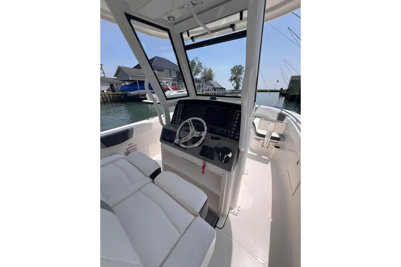 Slide: The Image of 2022 Robalo R272 Center Console boat interior with seating and console view. - 9