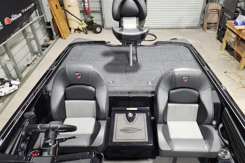 Slide: The Image of 2026 Tracker Grizzly 12 Jon boat interior with gray seating and steering console. - 12