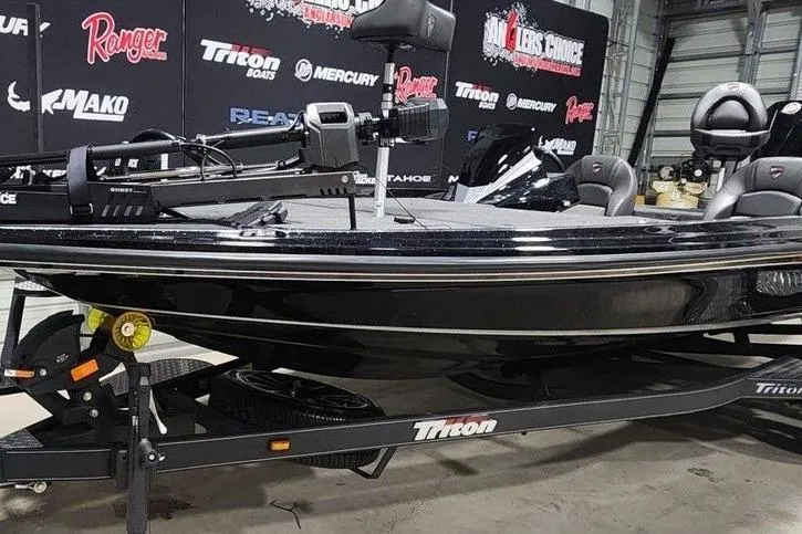 Slide: The Image of 2026 Tracker Grizzly 12 Jon boat on Triton trailer in showroom setting. - 3