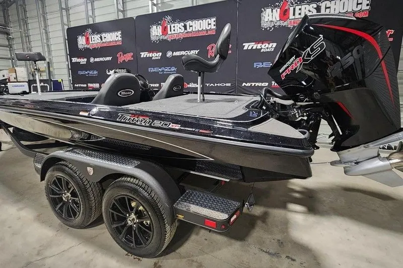 Slide: The Image of Black Triton 20 boat with powerful engine on display at Angler's Choice event. - 5