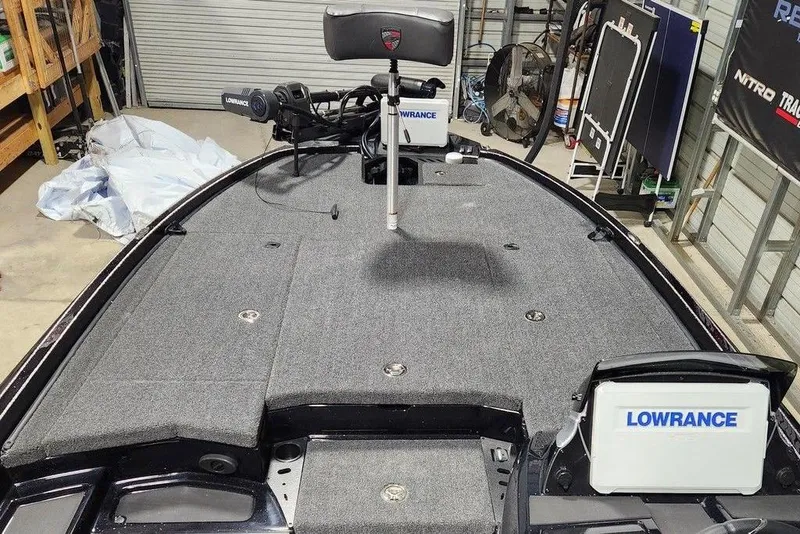 Slide: The Image of 2026 Tracker Grizzly 12 Jon boat interior with Lowrance equipment in a garage setting. - 7