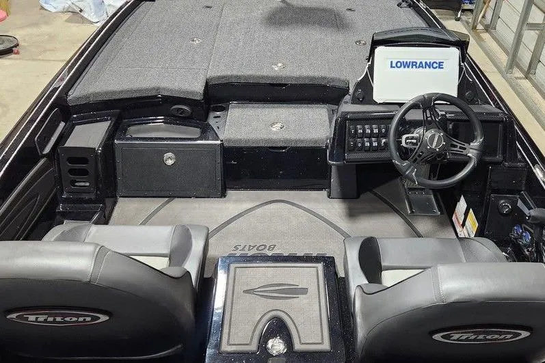 Slide: The Image of Interior of a 2026 Tracker Grizzly 12 Jon boat with Lowrance navigation system. - 8